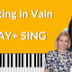 Yellow background with a piano keyboard on the bottom. Photo of Bob Marley wearing a blue shirt with a photo of Brenda Earle Stokes wearing a blue and white shirt with her thumb up. While lettering reads "Waiting in Vain PLAY + SING"